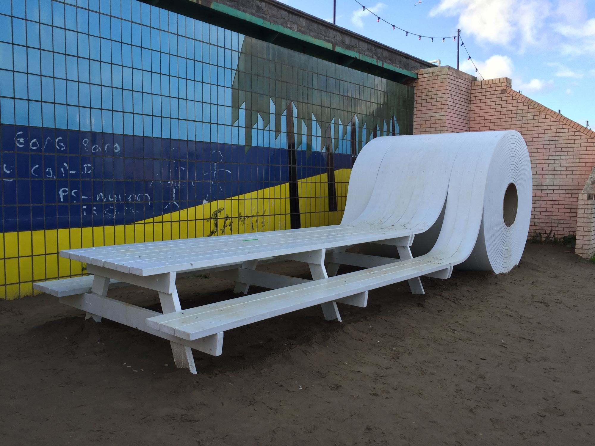 A picnic bench which turns into a roll of toilet paper