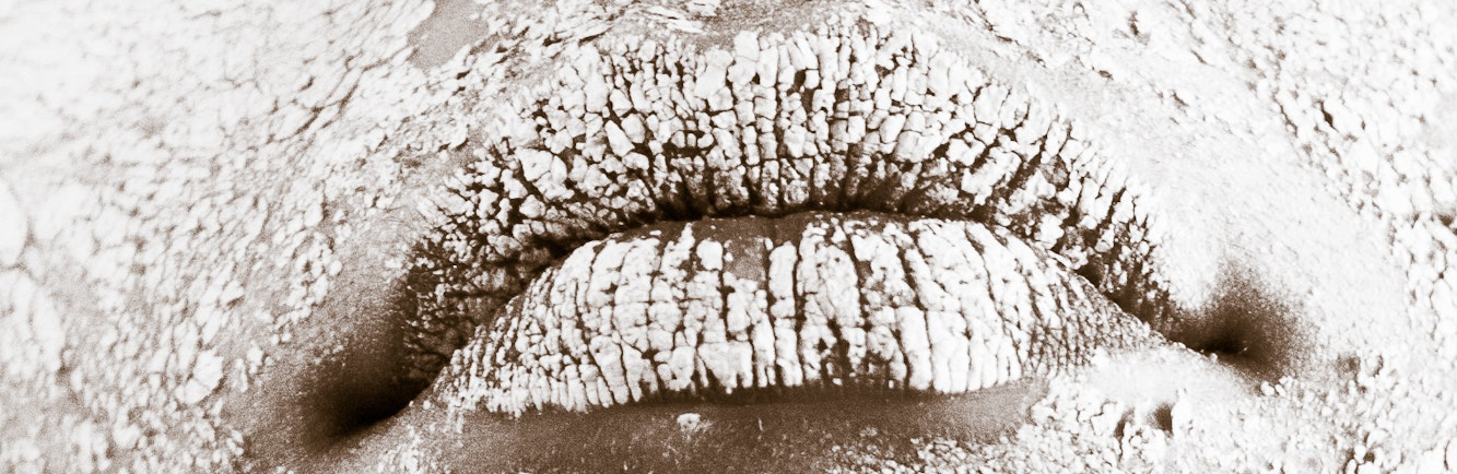 Woman's lips covered in what appears to be flour.